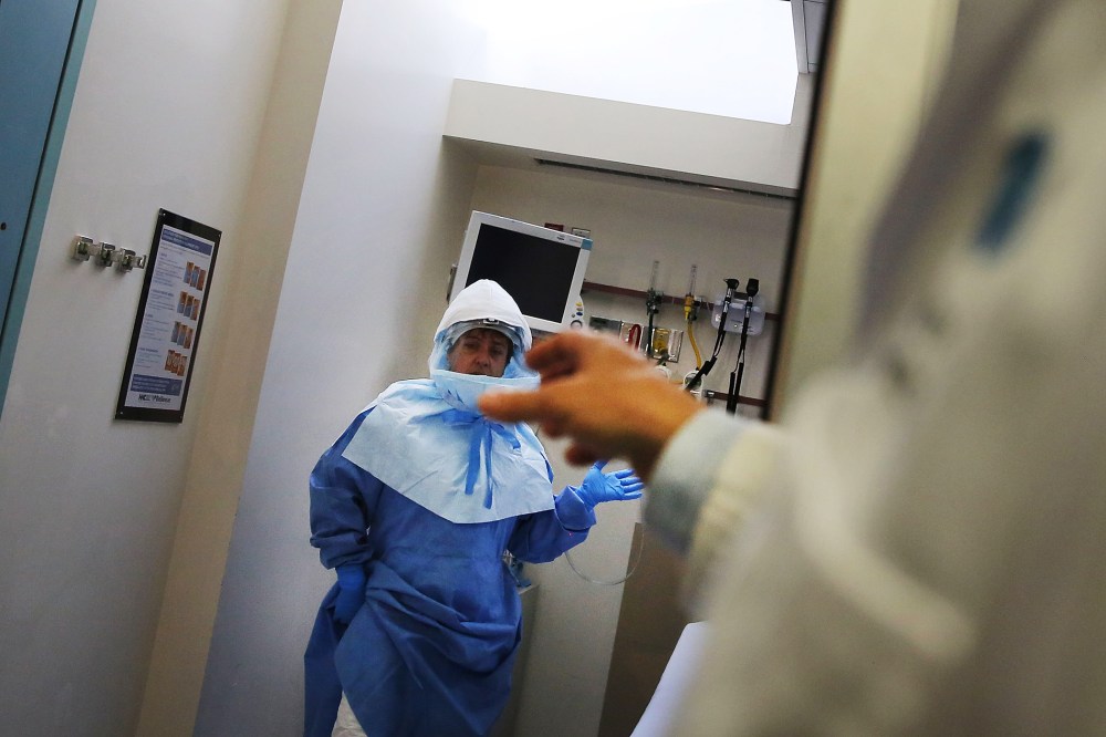 Members of Bellevue Hospital staff wear protective clothing as they demonstrate how they would receive a suspected Ebola patient on October 8, 2014 in New York City.