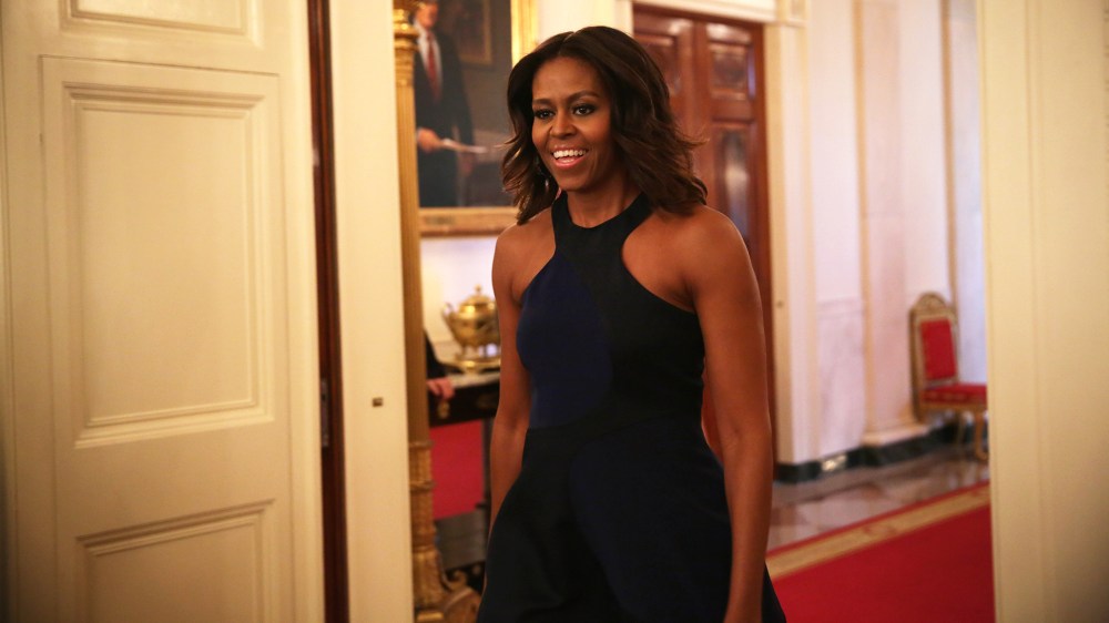 U.S. first lady Michelle Obama enters the East Room for a session of a Fashion Education Workshop at the White House on Oct. 8, 2014 in Washington, D.C. (Photo by Alex Wong/Getty)