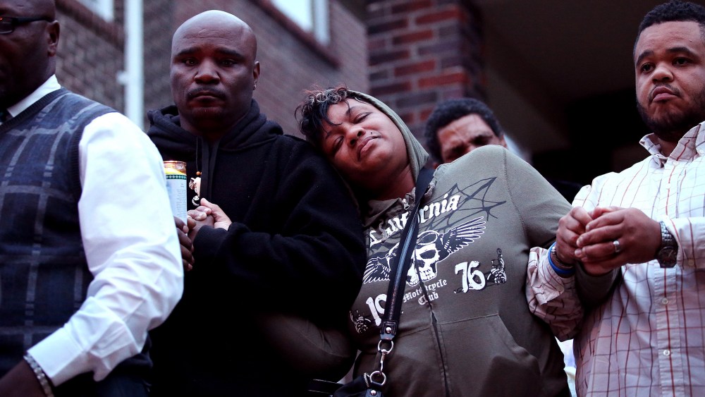 Family members attend a candlelight vigil for 18-year-old Vonderrit Myers Jr. on Oct. 9, 2014 in St Louis, Mo. Meyers was shot and killed by an off duty St. Louis police officer.