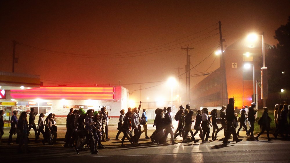 Demonstrators march through the street on Oct. 13, 2014 in St Louis, Mo. (Photo by Scott Olson/Getty)