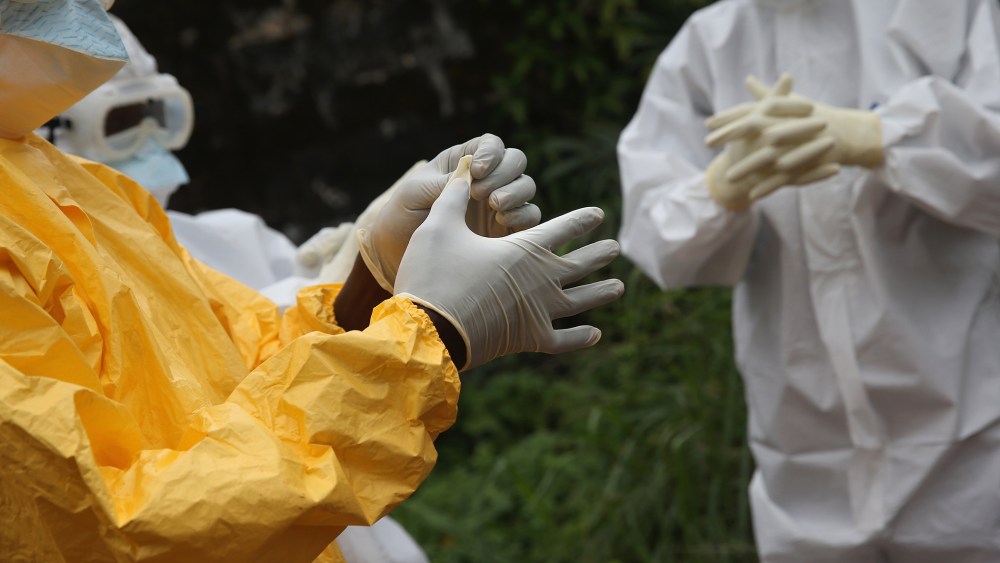 Health workers dress in protective clothing at the Island Clinic Ebola treatment center on Oct. 13, 2014 in Monrovia, Liberia. (John Moore/Getty)