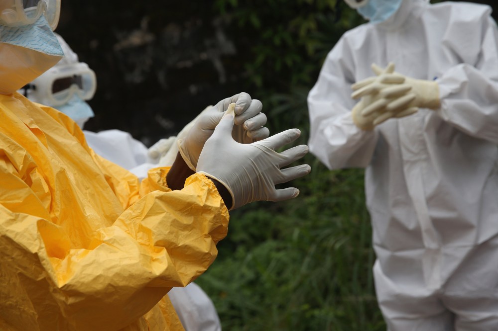 Health workers dress in protective clothing at the Island Clinic Ebola treatment center on Oct. 13, 2014 in Monrovia, Liberia. (John Moore/Getty)