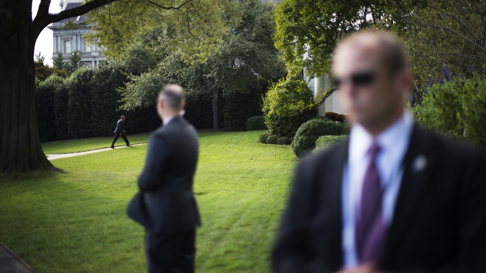 US Secret Service officers stand watch as US President Barack Obama returns to the Oval Office at the White House in Washington, D.C., Oct. 14, 2014. (Photo by Jim Watson/AFP/Getty)
