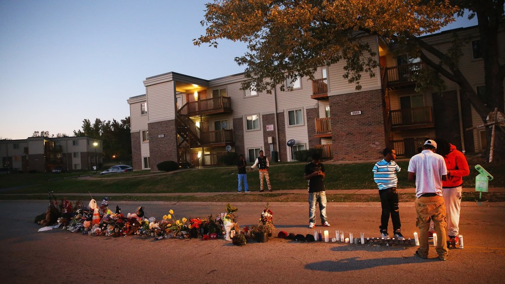 Neighborhood residents hang out at a memorial for 18-year-old Michael Brown on Canfield Street on Oct. 20, 2014 in Ferguson, Mo. (Photo by Scott Olson/Getty)