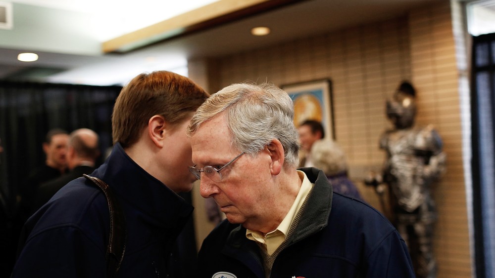 Senate Minority Leader Mitch McConnell (R-KY) (R) confers with an aide after speaking at a campaign rally Oct. 22, 2014 in Grayson, Ky.