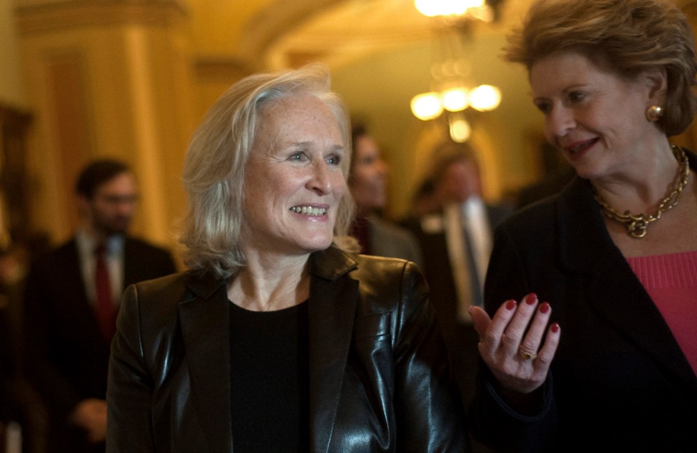 Glenn Close and Debbie Stabenow attend a press conference advocating for the passing of the Excellence In Mental Health Act on Dec. 18, 2013 in Washington D.C.