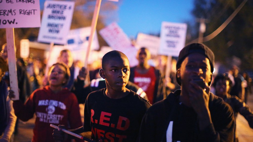 Demonstrators march toward the police station as protests continue in the wake of 18-year-old Michael Brown's death on Oct. 22, 2014 in Ferguson, Mo.