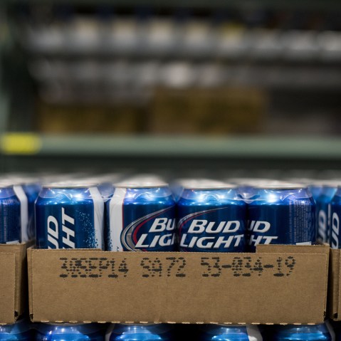 Cans of Anheuser-Busch Bud Light brand beer sits in a warehouse at Brewers Distributing Co. in Peoria, Illinois, U.S., on Oct. 30, 2014. (Photo by Daniel Acker/Bloomberg/Getty)