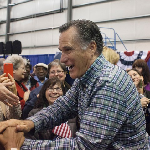 Former Massachusetts Gov. Mitt Romney greets the crowd during a rally for Republican Senate candidate Dan Sullivan on Nov. 3, in Anchorage, Alaska. (Photo by David Ryder/Getty)
