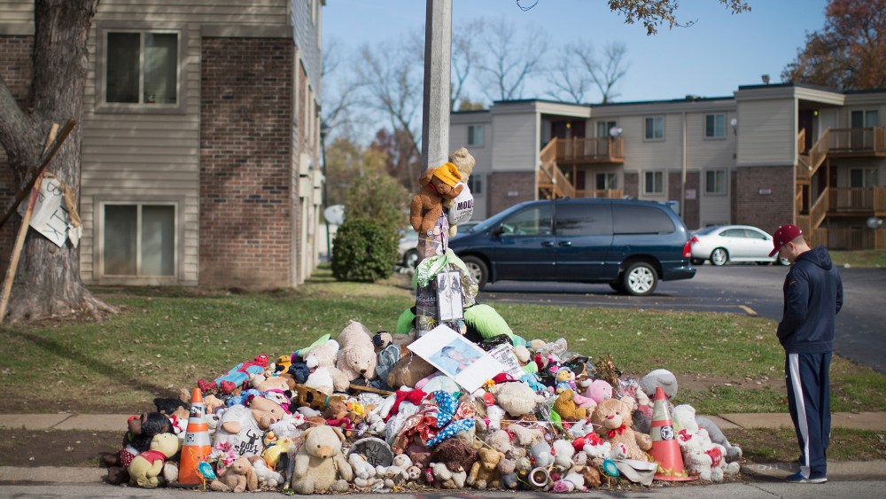 Greg Bajema views the memorial of stuffed animals, flowers, tee-shirts and ball caps that remains on Nov. 5, 2014 in Ferguson, Mo. (Scott Olson/Getty)