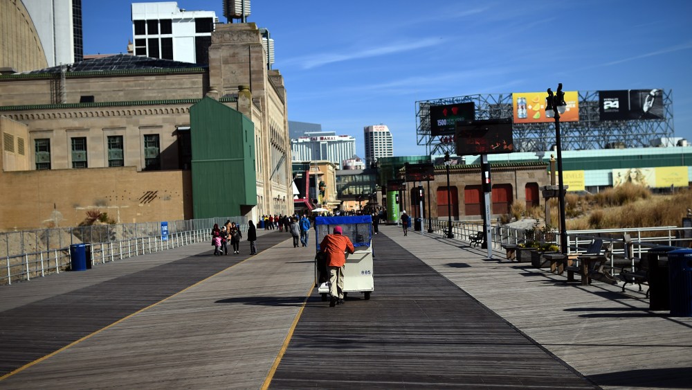 A man moves passengers on a "push cab" along the boardwalk in Atlantic City, N.J., on Nov. 8, 2014. (Photo by Jewel Samad/AFP/Getty)