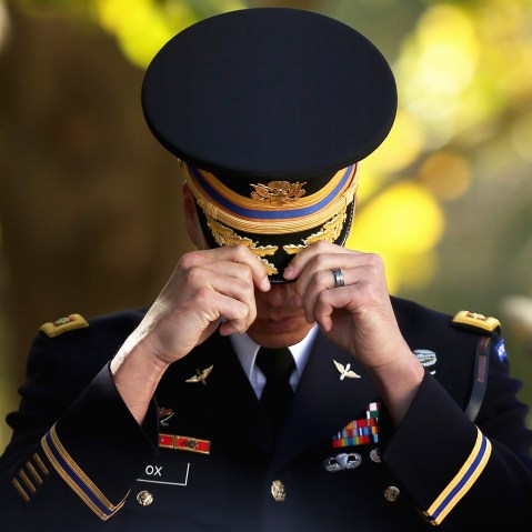 An officer from the 3rd U.S. Infantry Regiment adjusts his cover at The Tomb of the Unknown Soldier during Veterans Day observations at Arlington National Cemetery on Nov. 11, 2014 in Arlington, Va. (Photo by Chip Somodevilla/Getty)