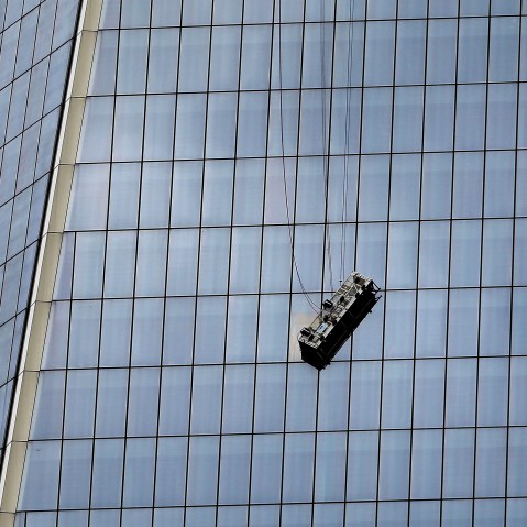 A scaffold carrying two workers hangs 69 floors up at One World Trade Center on Nov. 12, 2014 in New York City.