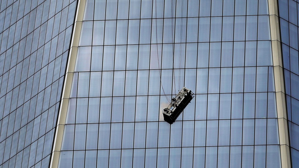 A scaffold carrying two workers hangs 69 floors up at One World Trade Center on Nov. 12, 2014 in New York City.