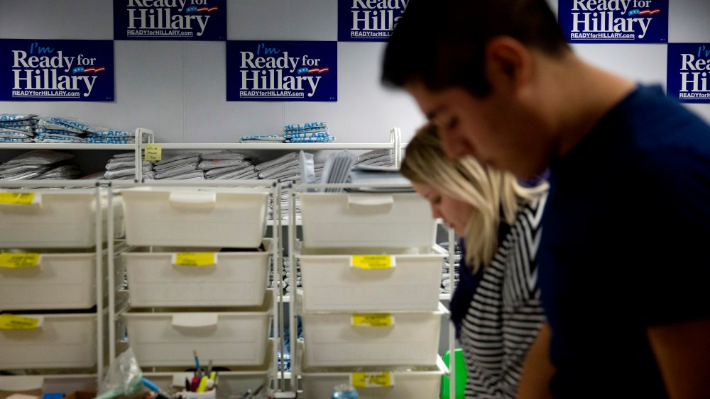"I'm Ready for Hillary" posters hang on the wall as interns fulfill customer's orders at the Ready For Hillary PAC headquarters store in Arlington, Virginia, on Nov. 12, 2014. (Photo by Andrew Harrer/Bloomberg via Getty)