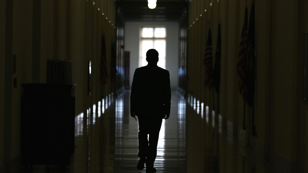 A man is silhouetted as he walks down a hallway in the Cannon House Office Building on Capitol Hill on Nov. 14, 2014 in Washington, D.C. (Photo by Mark Wilson/Getty)