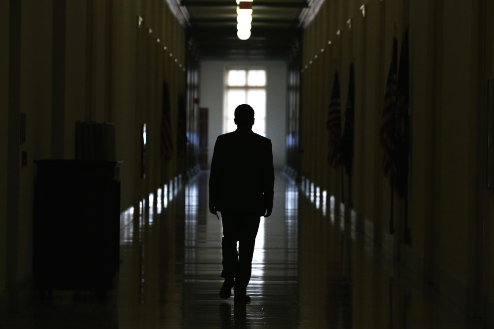 A man is silhouetted as he walks down a hallway in the Cannon House Office Building on Capitol Hill on Nov. 14, 2014 in Washington, D.C. (Photo by Mark Wilson/Getty)