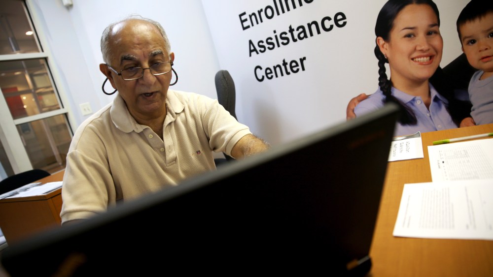Narendra Parmar finishes the process of picking and signing up for health insurance through the Affordable Care act at a Miami Enrollment Assistance Center, Dec. 23, 2013 in Miami, Fla.