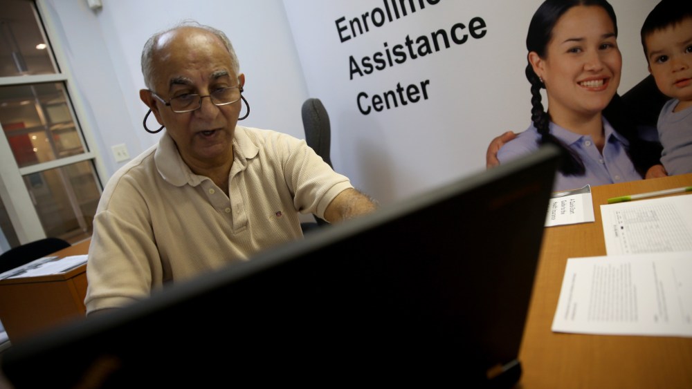 Narendra Parmar finishes the process of picking and signing up for health insurance through the Affordable Care act at a Miami Enrollment Assistance Center on December 23, 2013 in Miami, Florida.