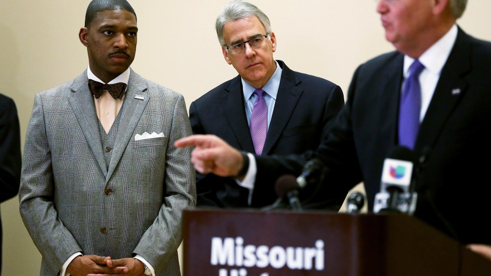 Minister Starsky Wilson (L) and businessman Richard McClure listen as Missouri Governor Jay Nixon, speaks to the media after announcing them as the co-chairs of a 16-member Ferguson Commission on Nov. 18, 2014 in St. Louis, Mo. (Photo by Joe Raedle/Getty)