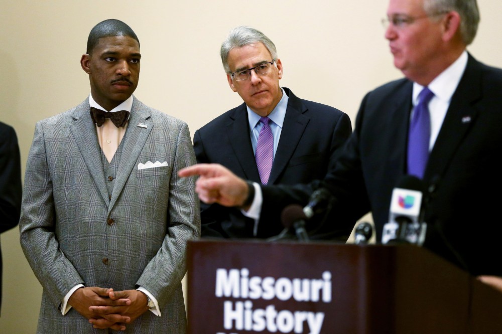 Minister Starsky Wilson (L) and businessman Richard McClure listen as Missouri Governor Jay Nixon, speaks to the media after announcing them as the co-chairs of a 16-member Ferguson Commission on Nov. 18, 2014 in St. Louis, Mo. (Photo by Joe Raedle/Getty)