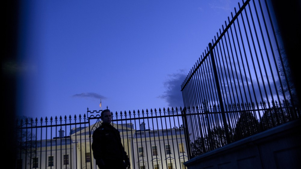 A member of the Secret Service's uniformed division stands by a fence in front of the White House on Nov. 20, 2014 in Washington, DC. (Photo by Brendan Smialowski/AFP/Getty)