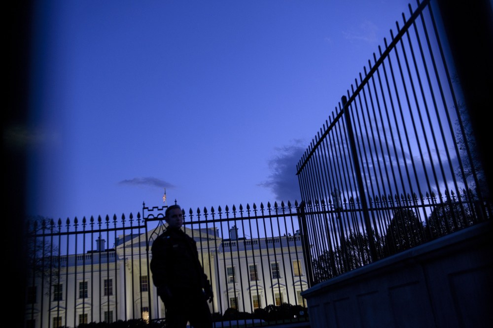 A member of the Secret Service's uniformed division stands by a fence in front of the White House on Nov. 20, 2014 in Washington, DC. (Photo by Brendan Smialowski/AFP/Getty)