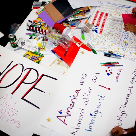 Attendees make signs at the offices of 32BJ SEIU, a workers union, during a viewing party for U.S. President Barack Obama's speech on evecutive action immigration policy reform on Nov. 20, 2014 in New York City. (Photo by Kevin Hagen/Getty)