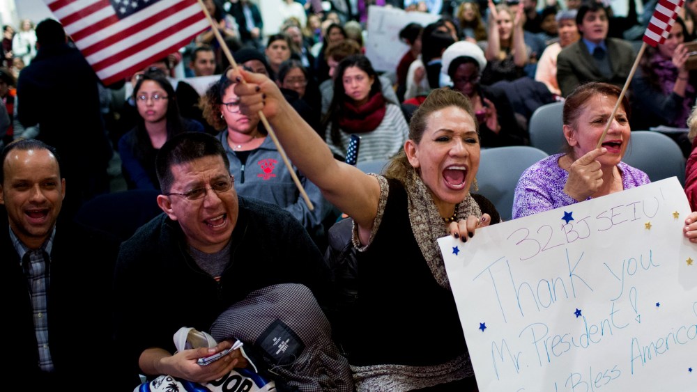 Lilian Aguayo (L), Fadila Mrkulic and Tatiana Lambert hold signs and wave flags during a viewing party for resident Barack Obama's speech on executive action immigration policy reform on Nov. 20, 2014 in New York, N.Y. (Photo by Kevin Hagen/Getty)
