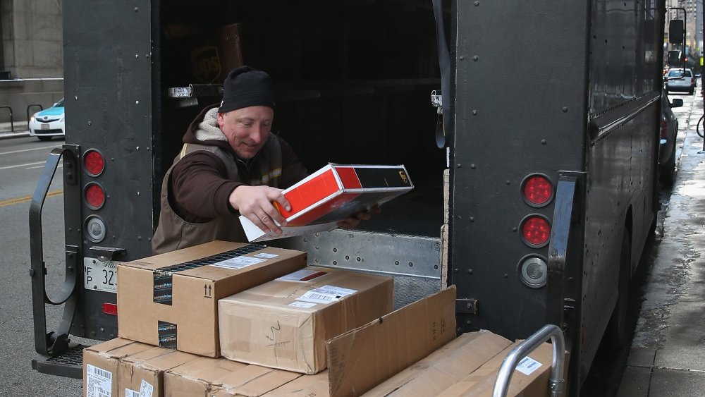 A UPS worker delivers packages on December 26, 2013 in Chicago, Illinois.