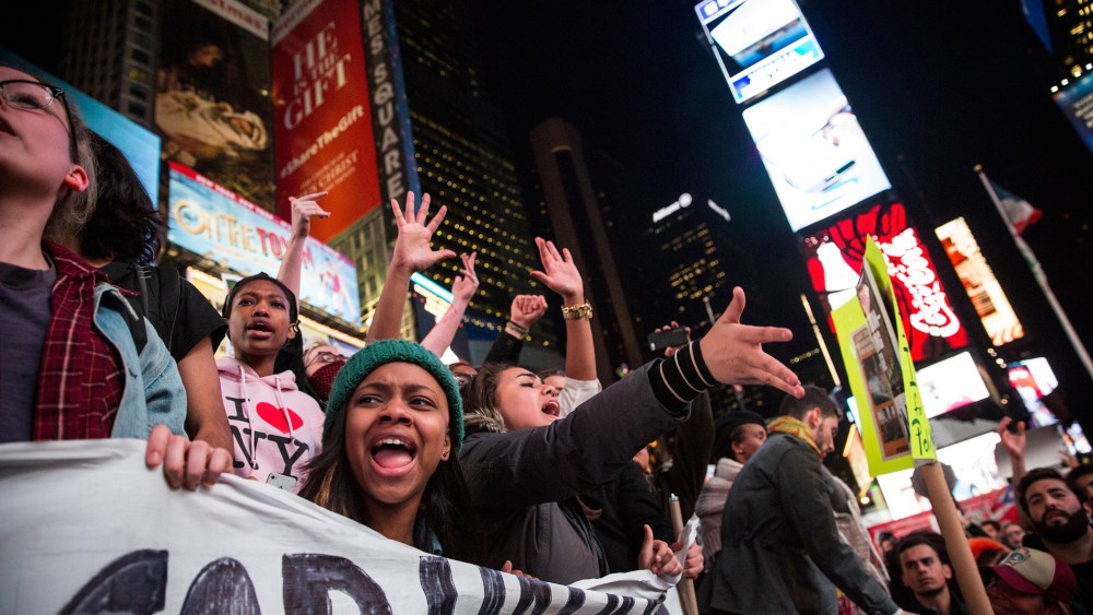 People protest in Times Square over the Ferguson grand jury decision to not indict officer Darren Wilson in the Michael Brown case Nov. 25, 2014 in New York, N.Y. (Photo by Andrew Burton/Getty)