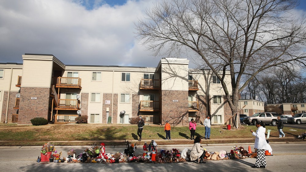 People visit the Michael Brown memorial in the Canfield Green Apartments on Nov. 27, 2014 in Ferguson, Mo. (Photo by Scott Olson/Getty)