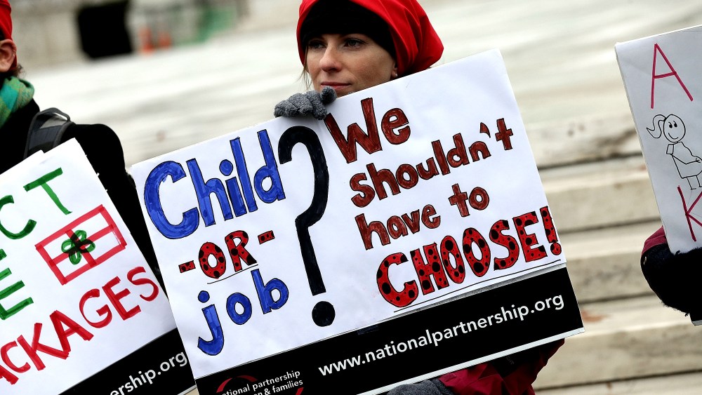 Protesters gather outside the U.S. Supreme Court while the court hears arguments in the Young vs. UPS case Dec. 3, 2014 in Washington, DC. (Photo by Win McNamee/Getty)