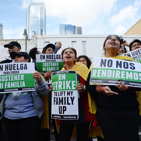 Fast food workers, healthcare workers and their supporters shout slogans at a rally and march to demand an increase of the minimum wage in Los Angeles, Calif. on Dec. 4, 2014. (Photo by Robyn Beck/AFP/Getty)