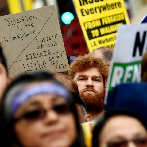 Fast food workers, healthcare workers and their supporters shout slogans at a rally and march to demand an increase of the minimum wage to 15USD per hour, in Los Angeles on Dec. 4, 2014. (Photo by Robyn Beck/AFP/Getty)