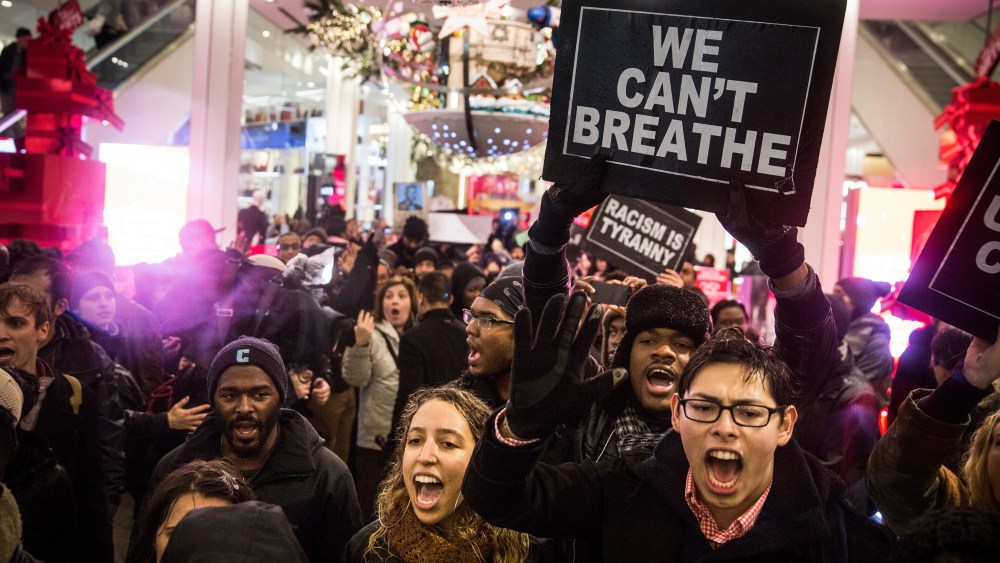 Demonstrators storm the Macy's on 34th Street protesting the Staten Island, N.Y. grand jury's decision not to indict a police officer involved in the chokehold death of Eric Garner in July on Dec. 5, 2014 in New York City. (Andrew Burton/Getty)