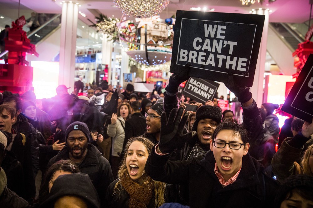 Demonstrators storm the Macy's on 34th Street protesting the Staten Island, N.Y. grand jury's decision not to indict a police officer involved in the chokehold death of Eric Garner in July on Dec. 5, 2014 in New York City. (Andrew Burton/Getty)