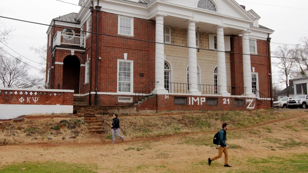 Students walk past the Phi Kappa Psi fraternity house on the University of Virginia campus on Dec. 6, 2014 in Charlottesville, Va.