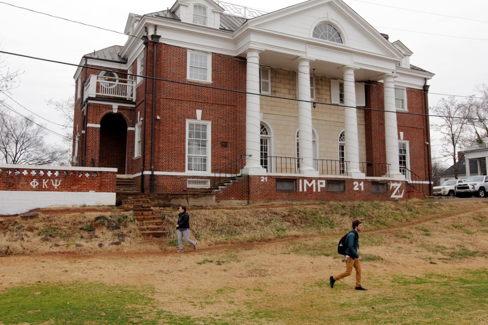 Students walk past the Phi Kappa Psi fraternity house on the University of Virginia campus on Dec. 6, 2014 in Charlottesville, Va.