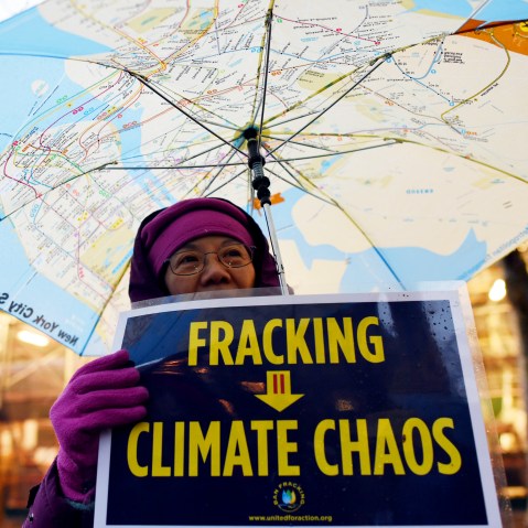 A woman holds an anti-fracking sign as a group of demonstrators gather for a rally for a Global Climate Treaty Dec. 10, 2014 near the United Nations in New York. (Photo by Don Emmert/AFP/Getty)