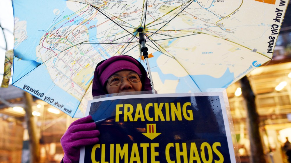 A woman holds an anti-fracking sign as a group of demonstrators gather for a rally for a Global Climate Treaty Dec. 10, 2014 near the United Nations in New York. (Photo by Don Emmert/AFP/Getty)