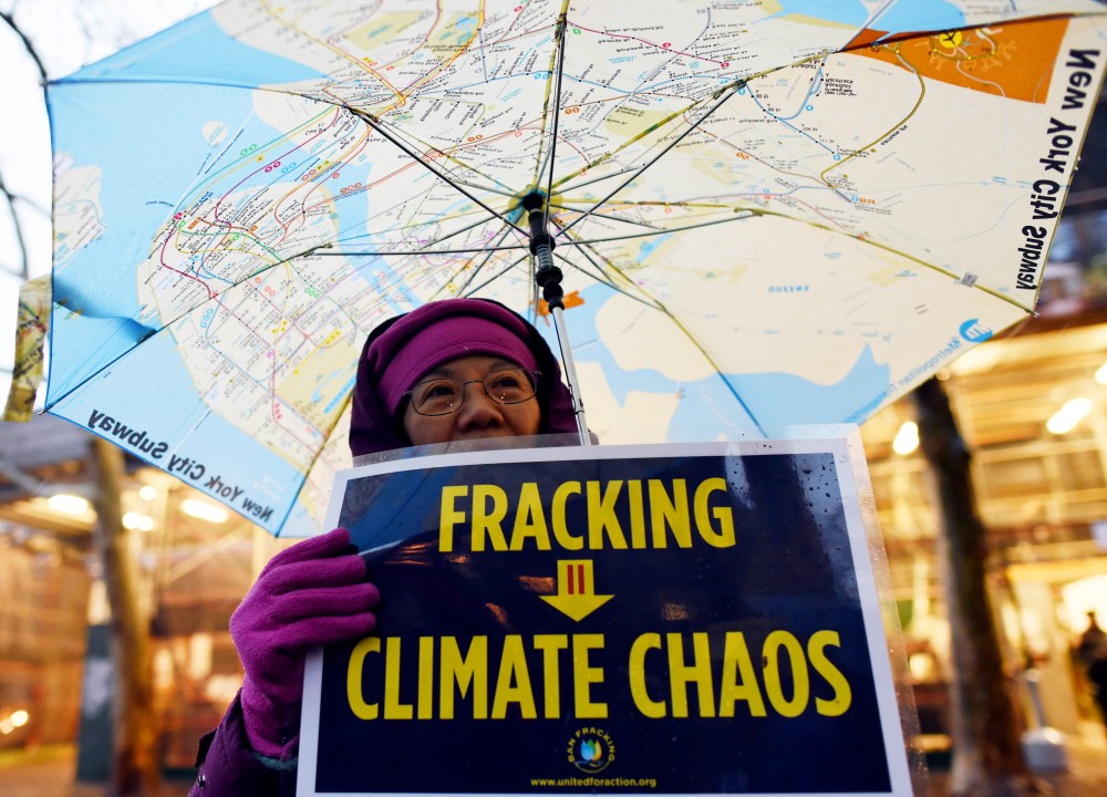 A woman holds an anti-fracking sign as a group of demonstrators gather for a rally for a Global Climate Treaty Dec. 10, 2014 near the United Nations in New York. (Photo by Don Emmert/AFP/Getty)
