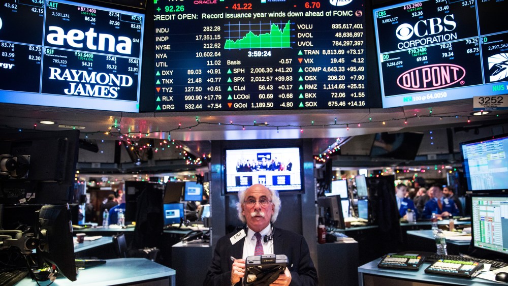A trader works on the floor of the New York Stock Exchange during the afternoon of Dec. 17, 2014 in New York, N.Y. (Photo by Andrew Burton/Getty)