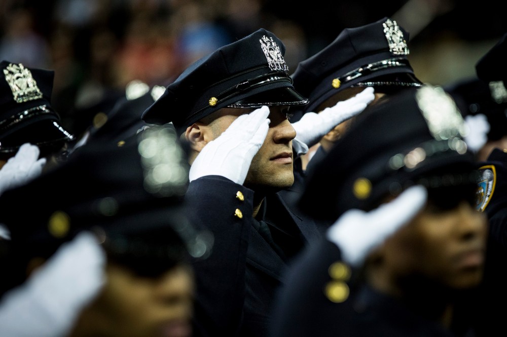 Police officers attend their New York Police Department graduation ceremony at Madison Square Garden on Dec. 29, 2014 in New York City.