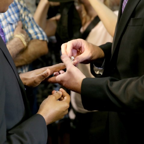 Newlyweds Jeff Delmay and Todd Delmay (L-R) exchange rings during a marriage ceremony in the Miami-Dade court room of Circuit Judge Sarah Zabel on Jan. 5, 2015 in Miami, Fla.