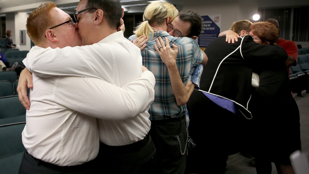 Newlyweds embrace after getting married during a ceremony at the Broward County Courthouse on Jan. 6, 2015 in Fort Lauderdale, Fla. (Photo by Joe Raedle/Getty)