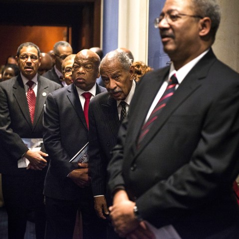 Rep. Charles Rangel (D-NY) and Rep. John Lewis (D-GA) along with other members of the Congressional Black Caucus line up before the swearing-in ceremony at the U.S. Capitol on Jan. 6, 2015 in Washington, D.C.