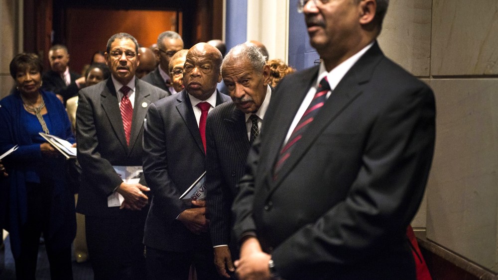 Rep. Charles Rangel (D-NY) and Rep. John Lewis (D-GA) along with other members of the Congressional Black Caucus line up before the swearing-in ceremony at the U.S. Capitol on Jan. 6, 2015 in Washington, D.C.