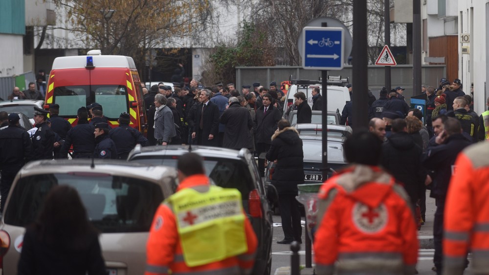 Ambulances and police officers gather in front of the offices of the French satirical newspaper Charlie Hebdo on Jan. 7, 2015 in Paris, France.