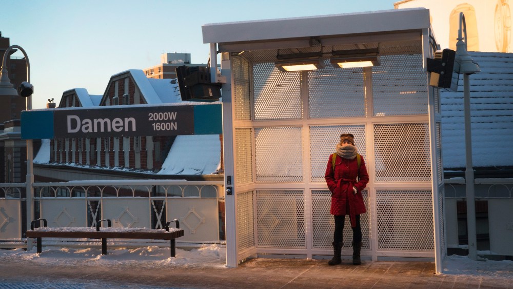 A woman tries to stay warm as she waits for a train on an L platform during the morning rush while temperatures hovered around zero degrees Fahrenheit on January 7, 2015 in Chicago, Illinois. (Photo by Scott Olson/Getty)